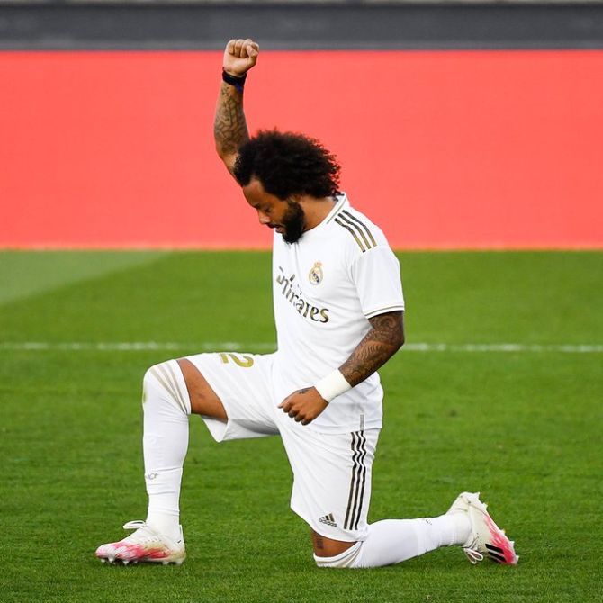 Real Madrid's Marcelo celebrates his goal against Eibar by kneeling and raising his right fist, an apparent tribute to the Black Lives Matter campaign, during their La Liga match on Sunday