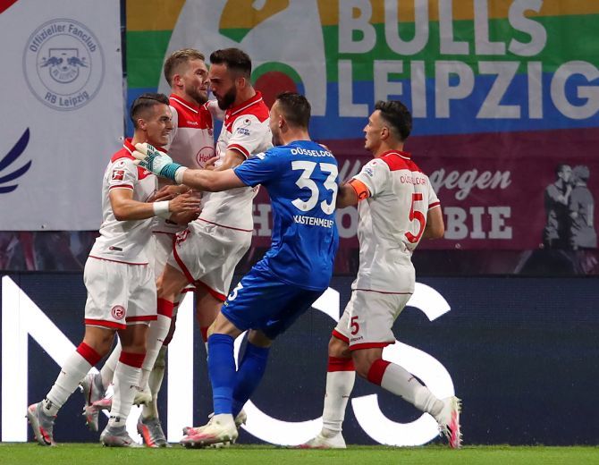 Fortuna Duesseldorf's Andre Hoffmann celebrates with teammates on scoring their second goal against RB Leipzig at Red Bull Arena, Leipzig