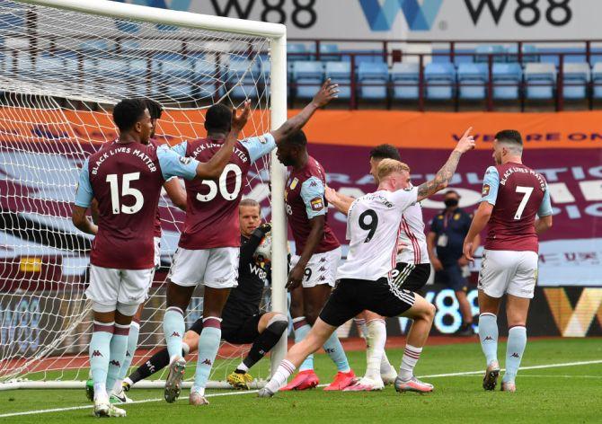 Aston Villa's 'keeper Orjan Nyland appears to carry the ball over the goalline, but the goal was not given and Sheffield were denied as the match ended in a draw at Villa Park in Birmingham.