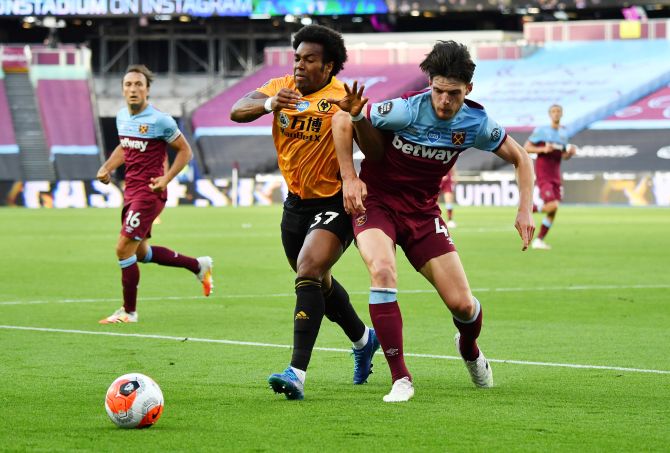 Wolverhampton Wanderers' Adama Traore and West Ham United's Declan Rice vie for possession during their match at London Stadium, London 