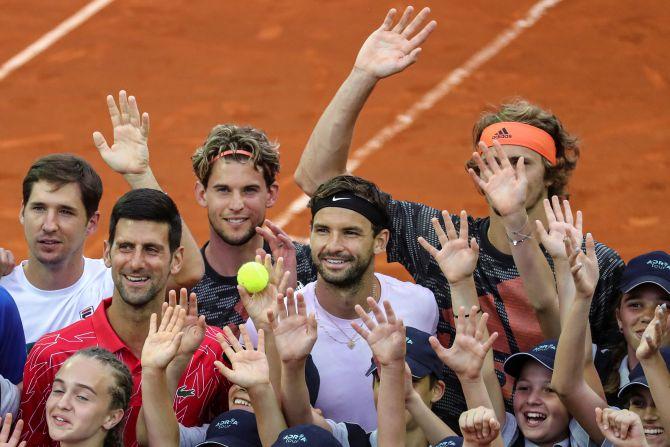 Bulgaria's Grigor Dimitrov, Serbia's Novak Djokovic, Dusan Lajovic, Austria's Dominic Thiem, Germany's Alexander Zverev pose for a photo with the ballkids during Adria Tour at Novak Tennis Centre in Belgrade, Serbia, on June 12