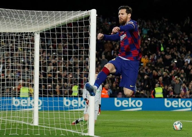 Lionel Messi celebrates scoring from the penalty spot during their La Liga match against Real Sociedad at Camp Nou, Barcelona, on Saturday. 