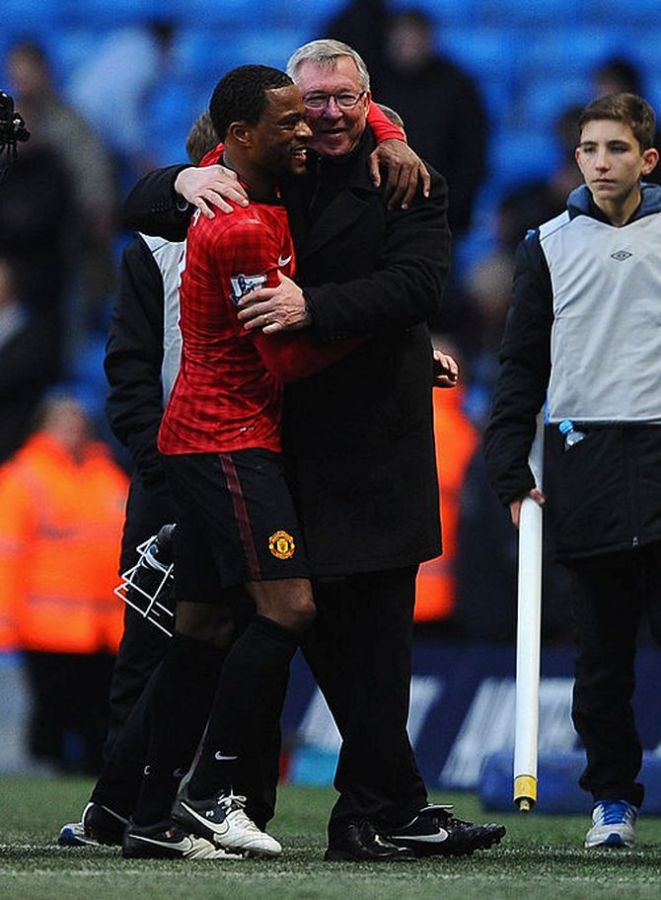 Patrice Evra with Alex Ferguson celebrate a win during their time at Manchester United