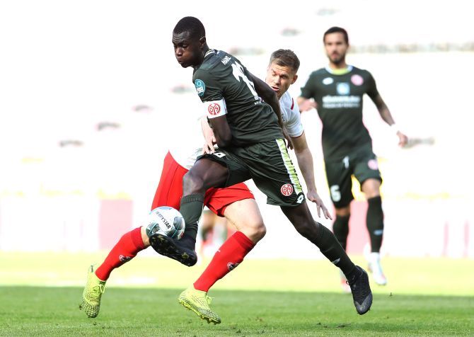 FSV Mainz 05's oussa Niakhate and FC Cologne's Simon Terodde vie for possession during their Bundesliga match played behind closed doors following the outbreak of the coronavirus disease (COVID-19) at RheinEnergieStadion, Cologne, Germany on Sunday.