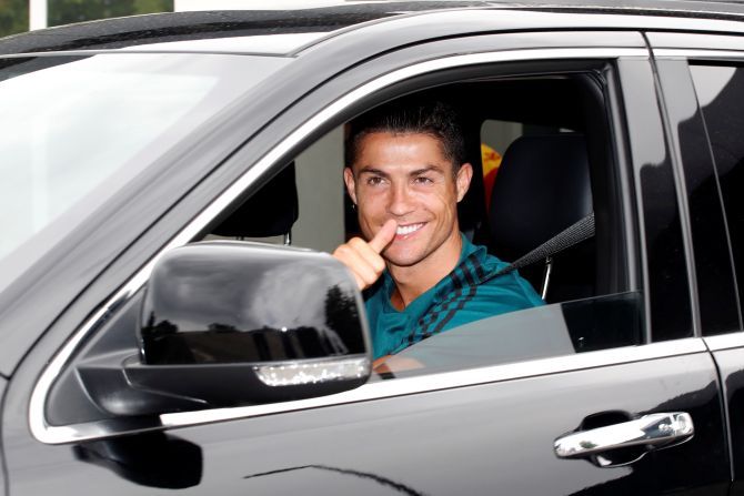 Juventus' Cristiano Ronaldo gestures as he leaves Juventus Training Center in Turin, Italy, on Tuesday