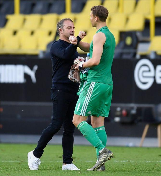 Bayern Munich manager Hansi Flick celebrates with captain and goalkeeper Manuel Neuer after their win over Dortmund on Tuesday