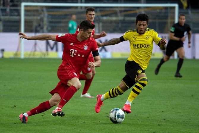 Borussia Dortmund's Jadon Sancho (right) and Bayern Munich's Robert Lewandowski vie for possession 