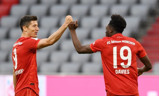Bayern Munich's Alphonso Davies celebrates scoring their fifth goal with Robert Lewandowski during their Bundesliga match against Fortuna Dusseldorf at Allianz Arena in Munich on Saturday