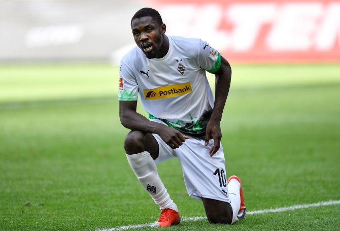 Borussia Moenchengladbach's Marcus Thuram kneels after celebrating their second goal against FC Union Berlin at Borussia Park, Moenchengladbach, Germany on Sunday. Thuram went down on his knee in memory of George Floyd, an unarmed black man who died in Minnesota after a white police officer knelt on his neck, sparking widespread protests in the United States