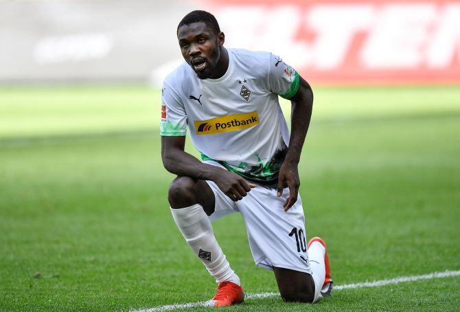 Borussia Moenchengladbach's Marcus Thuram kneels after celebrating their second goal against FC Union Berlin at Borussia Park, Moenchengladbach, Germany on Sunday. Thuram went down on his knee in memory of George Floyd, an unarmed black man who died in Minnesota after a white police officer knelt on his neck, sparking widespread protests in the United States.