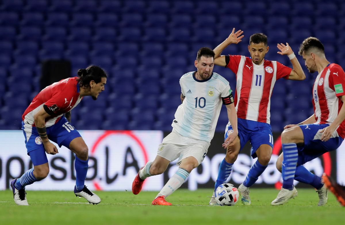 Argentina's Lionel Messi is challenged by Paraguay's Angel Romero during their World Cup 2022 South American Qualifiers at Estadio La Bombonera, Buenos Aires, Argentina on Thursday