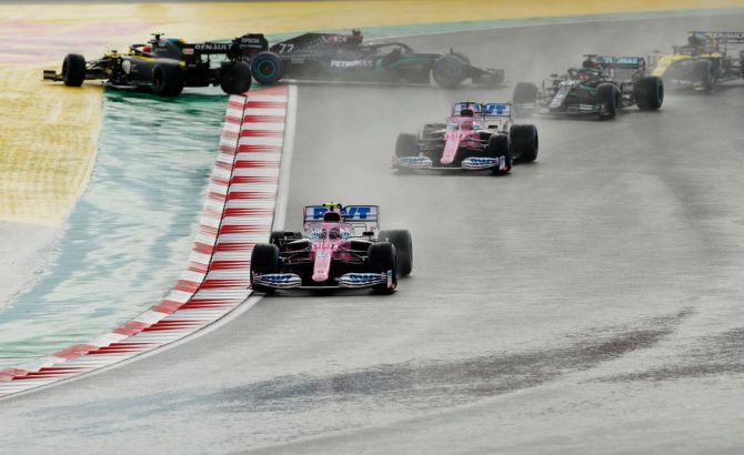 Racing Point RP20 Mercedes' Canadian driver Lance Stroll leads teammate and Mexican driver Sergio Perez and the rest of the field at the start of the F1 Grand Prix of Turkey 