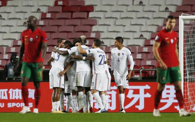 France's N'Golo Kante celebrates with with teammates on netting a goal against Portugal at Estadio da Luz, Lisbon, Portugal, on Saturday 