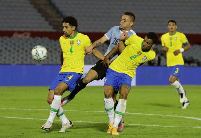Brazil's Danilo and Marquinhos in action with Uruguay's Jonathan Rodriguez 