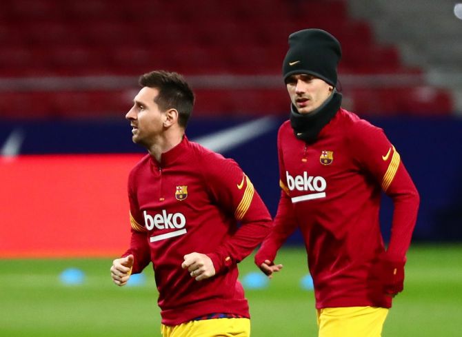 Barcelona's Lionel Messi and Antoine Griezmann during a warm-up session 