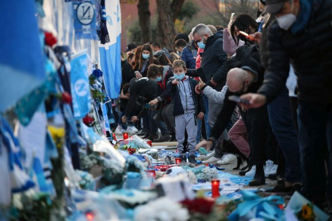 People are seen placing tributes in memory of Diego Maradona outside the stadium prior to the UEFA Europa League Group F stage match between SSC Napoli and HNK Rijeka at Stadio San Paolo in Naples, Italy, on Thursday 