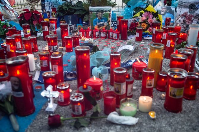 Tributes are seen on the fences in front of the San Paolo stadium during the mourning of the death of soccer player Diego Armando Maradona in Naples on Thursday. 