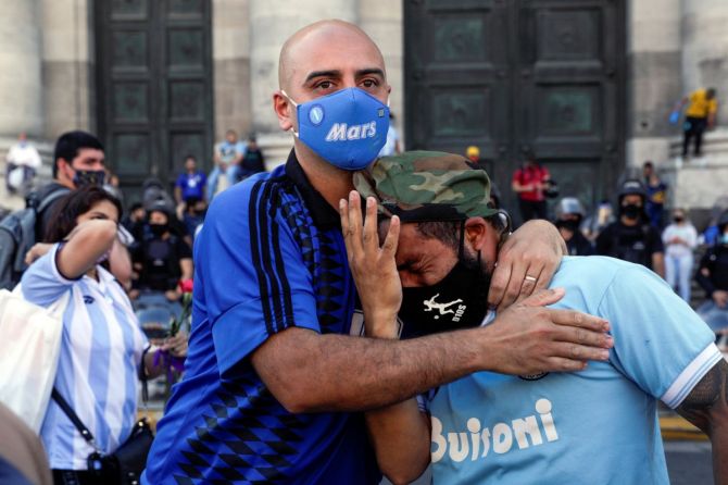 People mourn the death of soccer legend Diego Armando Maradona, in front of the Casa Rosada presidential palace in Buenos Aires at his funeral. 