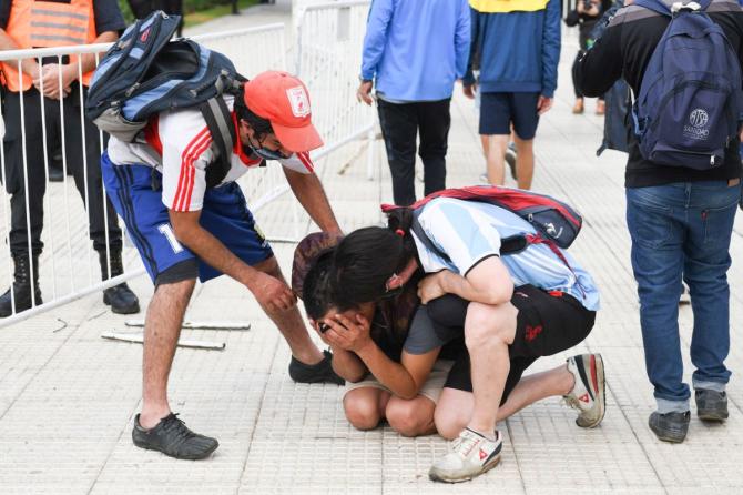 A fan breaks down during the funeral of Diego Maradona outside the Casa Rosada presidential palace in Buenos Aires, Argentina 