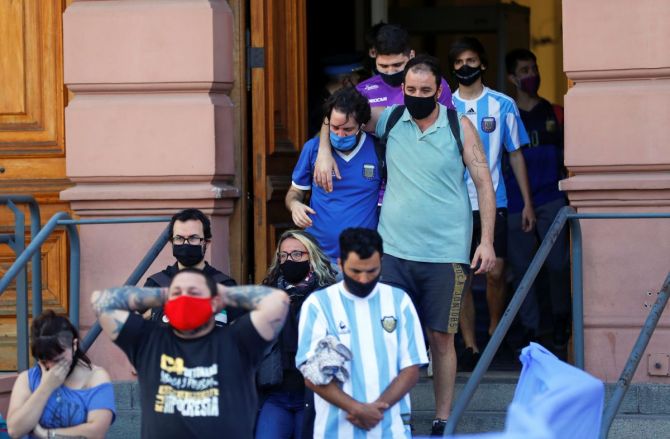 People leave the Casa Rosada presidential palace after attending the wake of Diego Maradona