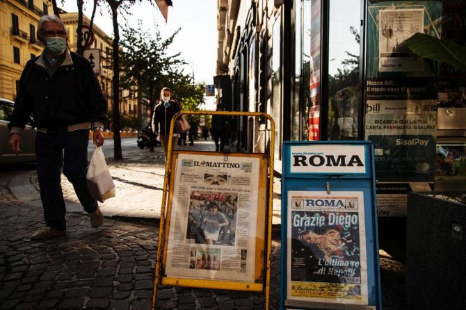 Covers of national newspapers are seen at a newsstand the day after the death of soccer player Diego Armando Maradona in Naples, Italy, on Thursday