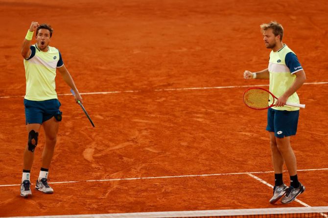 Kevin Krawietz and Andreas Mies of Germany celebrate a point against Mate Pavic of Croatia and Bruno Soares of Brazil in their French Open men's doubles Final on Court Philippe-Chatrier at Roland Garros on Saturday
