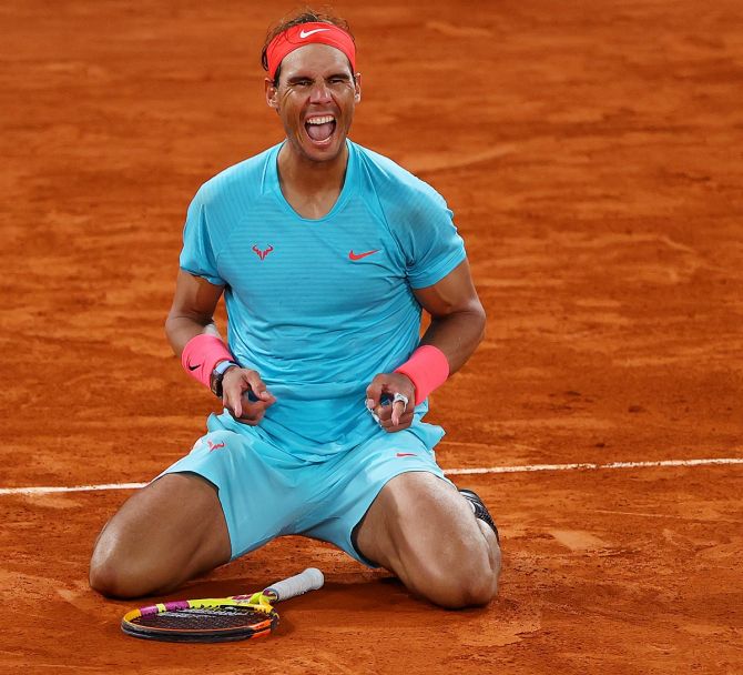 Rafael Nadal celebrates after winning championship point after defeating Novak Djokovic to win his 13th French Open title and a record-equalling 20th Grand Slam to tie with Roger Federer for most singles major titles
