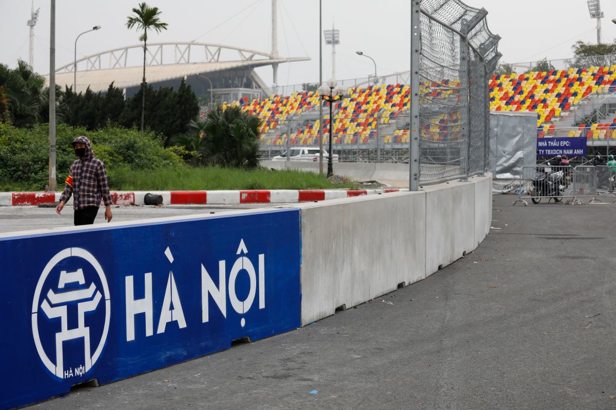 A man wears a protective mask as he guards at the construction site of Formula One Vietnam Grand Prix racing track in Hanoi, Vietnam.