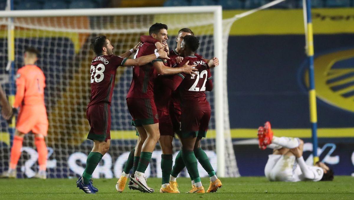 Wolverhampton Wanderers' Raul Jimenez celebrates with teammates after Leeds United's Kalvin Phillips scores an own goal and the first for Wolverhampton Wanderers during their EPL match at Elland Road, Leeds, on Monday