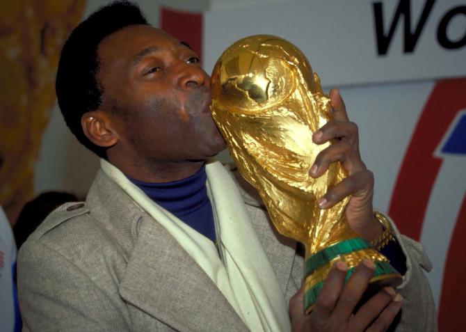 Brazil legend Pele kisses the FIFA World Cup trophy