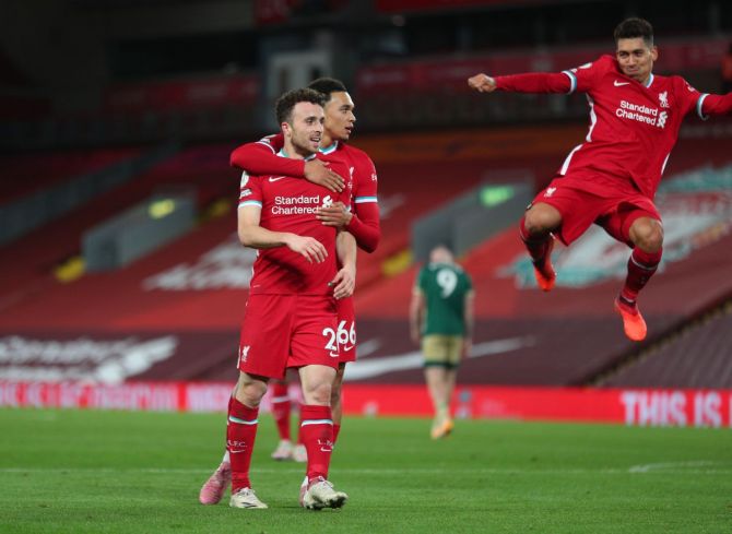 Liverpool's Diogo Jota celebrates with Roberto Firmino and Trent Alexander-Arnold after scoring their second goal against Sheffield United at Anfield on Saturday