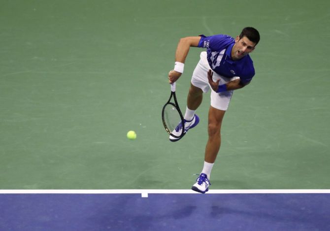 Novak Djokovic serves