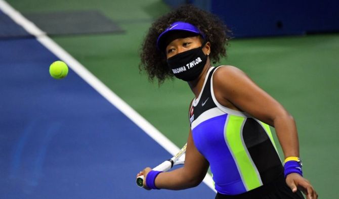 Japan's Naomi Osaka celebrates her first round win over compatriot Misaki Doi by hitting the ball in the stands