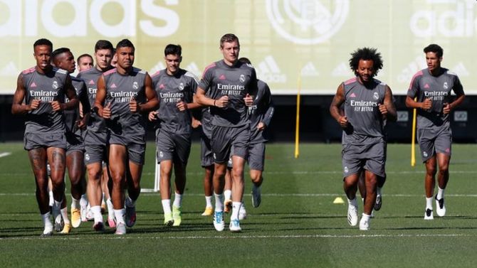 Real Madrid players warm-up during a training session on Friday