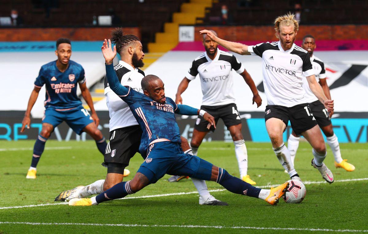 Arsenal's Alexandre Lacazette is challenged by Fulham's Michael Hector and Tim Ream as they vie for possession 