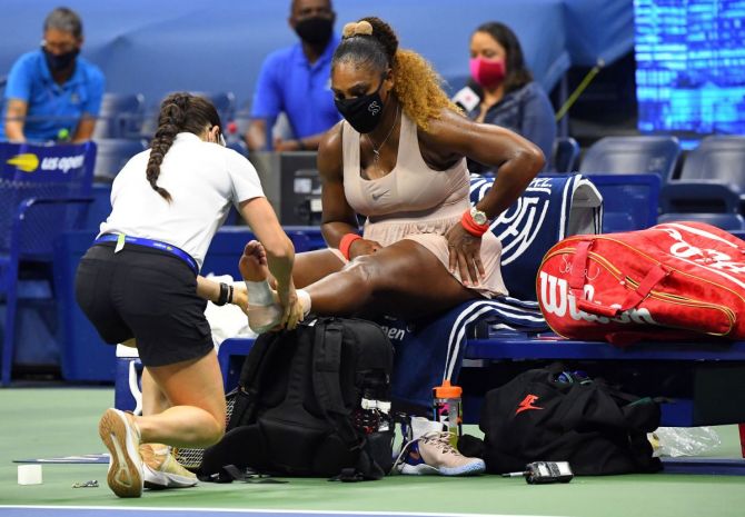 Serena Williams gets treatment for her left ankle during the US Open semi-final against Victoria Azarenka on Thursday