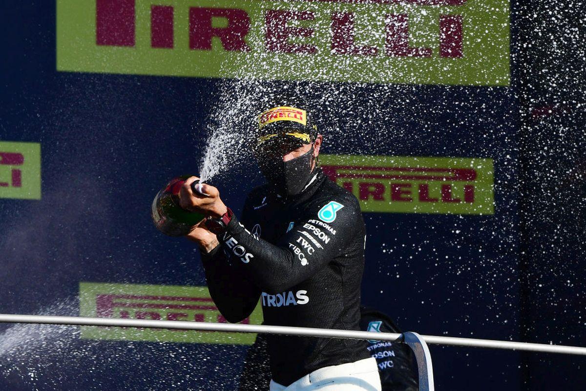 Race winner Lewis Hamilton of Great Britain and Mercedes GP celebrates on the podium