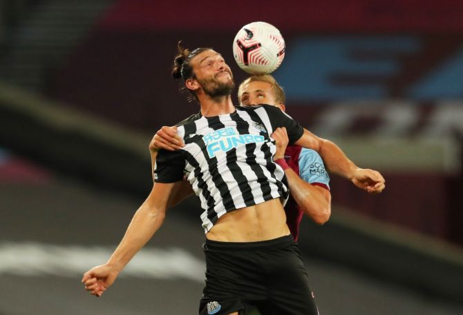 Newcastle United's Andy Carroll and West Ham United's Tomas Soucek in an aeriel duel during their EPL match at London Stadium on Saturday