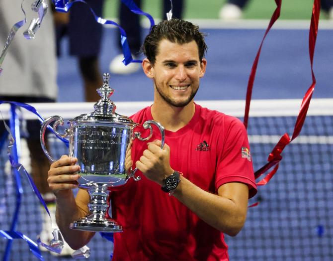 Austria’s Dominic Thiem celebrates with the championship trophy after winning the US Open in a tie-breaker against Germany's Alexander Zverev.