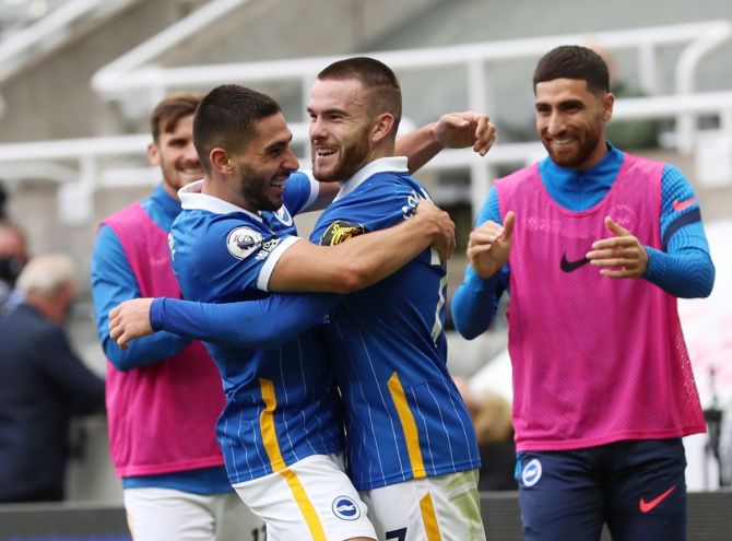 Aaron Connolly celebrates scoring Brighton & Hove Albion's third goal with Neal Maupay.