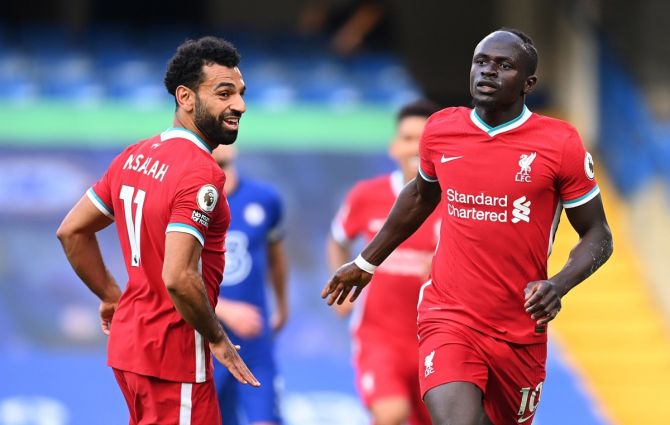 Sadio Mane celebrates scoring Liverpool's second goal with Mohamed Salah.