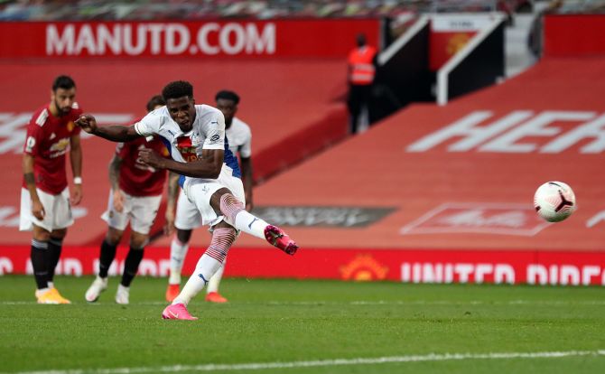 Wilfried Zaha of Crystal Palace scores a penalty for his team's second goal against Manchester United