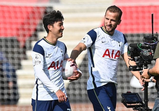 Tottenham Hotspur's Son Heung-min celebrates with the match ball and Harry Kane after the thumping victory over Southampton