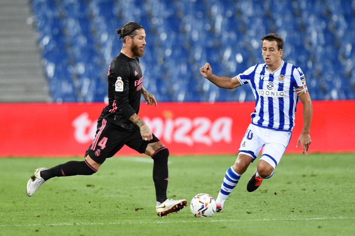 Real Madrid's Sergio Ramos battles for possession with Real Sociedad's Mikel Oyarzabal during their La Liga match at Estadio Anoeta in San Sebastian