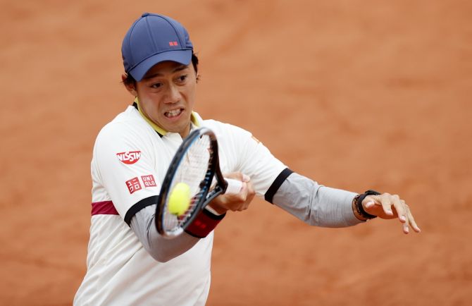 Japan's Kei Nishikori in action during his first round match against Britain's Dan Evans.