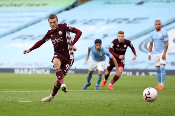 Jamie Vardy scores Leicester City's third goal from the peantly spot during the Premier League match against Manchester City, at Etihad Stadium on Sunday. 