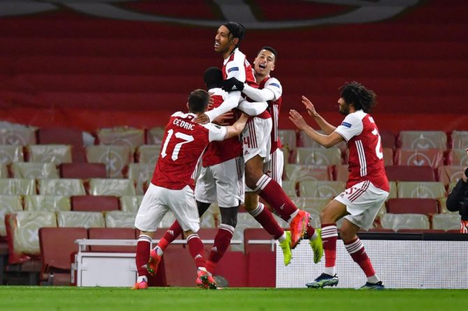 Arsenal's Nicolas Pepe celebrates scoring their first goal with teammates against Slavia Prague at Emirates Stadium.