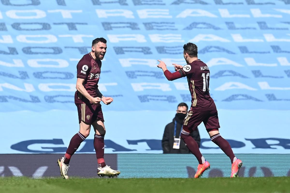 Stuart Dallas celebrates with Ezgjan Alioski after scoring Leeds United's first goal during the Premier League match against Manchester City