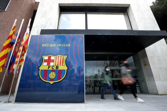 People leave the office of FC Barcelona, in Spain, as 12 of Europe's top football clubs launch a breakaway Super League