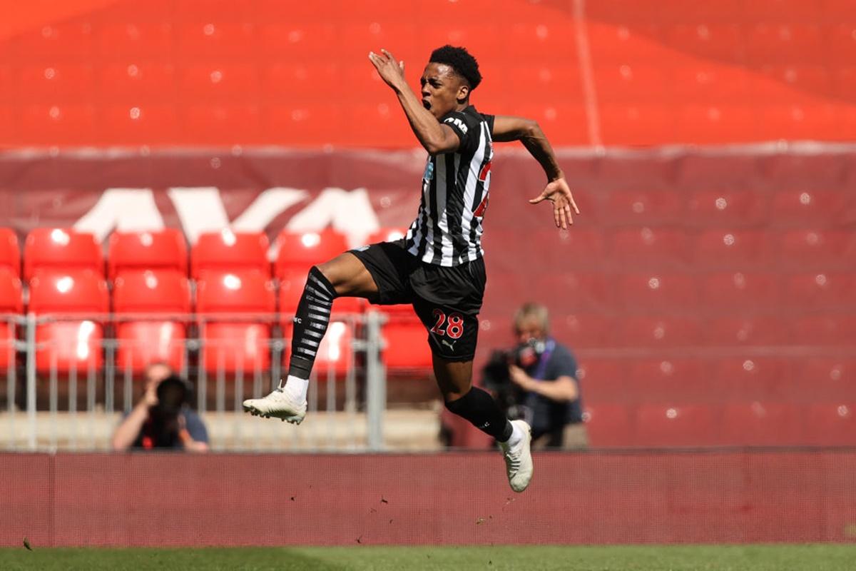 Joe Willock celebrates after scoring a late equaliser for Newcastle United in their Premier League match against Liverpool, at Anfield, on Saturday